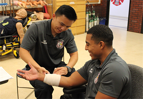 Students practicing EMT skills on their classmates.