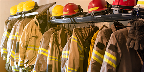 Firefighter gear hanging up on a rack. 